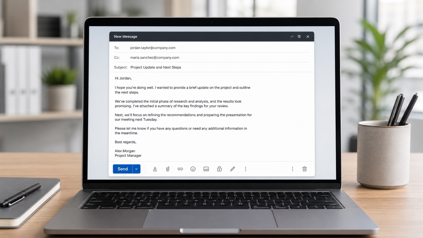 A technical professional writing a Japanese business email on a laptop